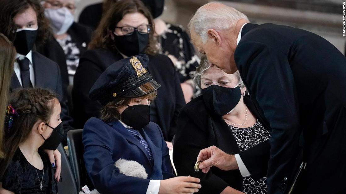 Biden gives a challenge coin to Logan Evans, son of the late Capitol Police Officer William &quot;Billy&quot; Evans, as the fallen officer was &lt;a href=&quot;https://www.cnn.com/2021/04/13/politics/capitol-police-officer-lie-in-honor-ceremony/index.html&quot; target=&quot;_blank&quot;&gt;lying in honor in the US Capitol Rotunda&lt;/a&gt; on April 13. Billy Evans, 41, died on April 2 after a man brandishing a knife rammed his vehicle into a police barricade outside the Capitol. &lt;br /&gt;&lt;br /&gt;Biden told Evans&#39; mother: &quot;I have some idea what you&#39;re feeling like. I buried two of my children.&quot; The President&#39;s first wife and daughter died in a car crash in 1972. Biden&#39;s son Beau died in 2015 of brain cancer.&lt;br /&gt;&lt;br /&gt;Logan wore the police hat and clutched a stuffed animal for most of the memorial service, photographer Drew Angerer said.