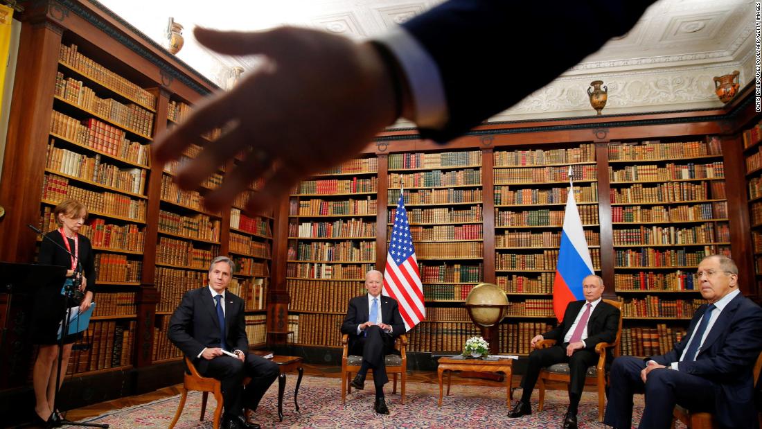 A security officer asks the media to step back at the start of the June 16 summit between Biden and Russian President Vladimir Putin. Seated from left are US Secretary of State Antony Blinken, Biden, Putin and Russian Foreign Minister Sergey Lavrov. &lt;br /&gt;&lt;br /&gt;&lt;a href=&quot;https://www.cnn.com/2021/06/16/politics/president-biden-president-putin-meeting/index.html&quot; target=&quot;_blank&quot;&gt;The summit,&lt;/a&gt; held in Geneva, Switzerland, was the first meeting of Biden and Putin since Biden was elected President.&lt;br /&gt;&lt;br /&gt;The library room was a tight fit for the presidents, their security teams and about 15 members of the media, Reuters photographer Denis Balibouse said. He tried to get a wide shot to capture the room&#39;s atmosphere. &quot;As there was still some disturbance from the media, the Swiss police asked everyone to leave the room, and that&#39;s when I noticed the hand of a Russian security officer in front of my lens and I tried to include it in the frame,&quot; Balibouse said.&lt;br /&gt;&lt;br /&gt;After the summit, both presidents described the meeting as generally positive but without any major breakthroughs. There were a few modest outcomes, including an agreement to return each country&#39;s ambassador to their post and assigning experts to focus on the growing problem of cyberattacks.