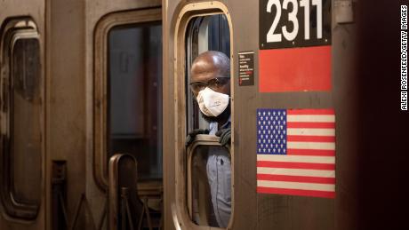  An MTA subway conductor wearing a KN95 face mask looks out of a window as the city continues Phase 4 of re-opening following restrictions imposed to slow the spread of coronavirus on August 9, 2020 in New York City. 