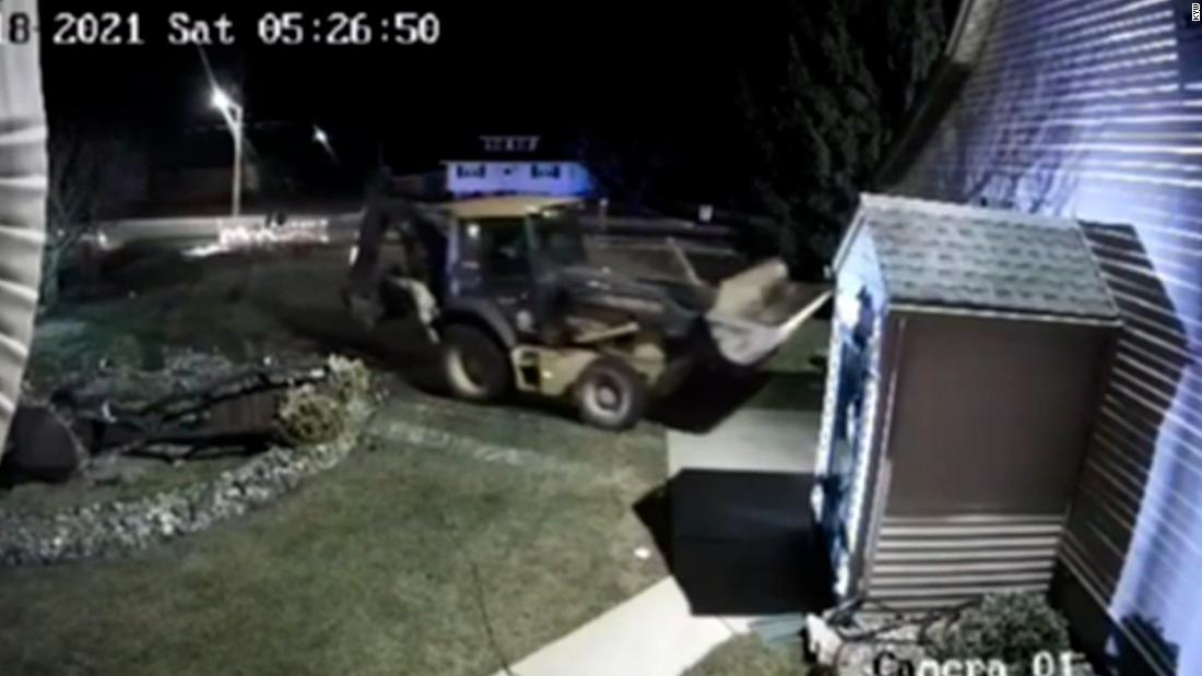 Dramatic video shows an officer fatally shoot a man who was driving a backhoe into homes and cars
