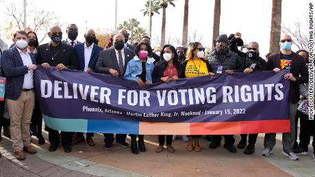 Rep. Ruben Gallego, D-Ariz. (left), the King family (middle) and local activists lead a march to call for voting rights on Saturday, January 15, 2021, in Phoenix.