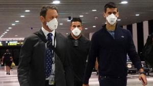 Serbian tennis player Novak Djokovic walks in Melbourne Airport before boarding a flight, after the Federal Court upheld a government decision to cancel his visa to play in the Australian Open, in Melbourne, Australia, January 16, 2022. 