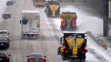 Vehicles navigate hazardous driving conditions along Interstate 85/40 as a winter storm moves through the area in Mebane, N.C., Sunday, Jan. 16, 2022. 