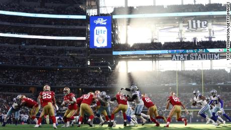 Jimmy Carpolo le pasa el balón a Elijah Mitchell durante el segundo cuarto contra los Dallas Cowboys.