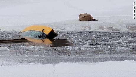 The car sank in the river after a woman drove across the frozen water. 