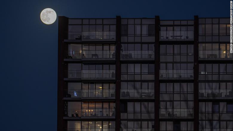 The full moon rises in the residential area of Eindhoven in the Netherlands on January 17.