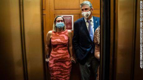 WASHINGTON, DC - SEPTEMBER 30: Sen. Kyrsten Sinema, D-Ariz., and Sen. Joe Manchin, D-W.Va., board an elevator after a private meeting between the two of them on Capitol Hill on Thursday, Sept. 30, 2021 in Washington, DC. (Photo by Jabin Botsford/The Washington Post via Getty Images)