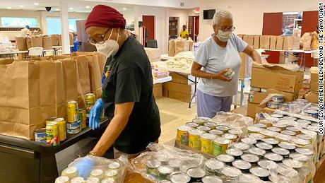 Volunteers organize food boxes at Beyond the Sanctuary, a non-profit organization in Rochester, New York, in June 2021. 