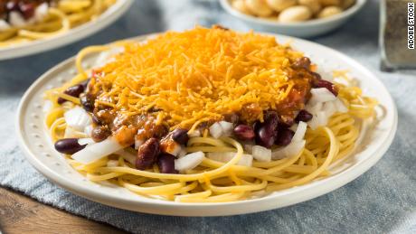 Cincinnati chili is made with hot spices, spaghetti, and a generous helping of shredded cheddar cheese.