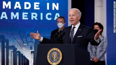 U.S. President Joe Biden (C) is joined by Commerce Secretary Gina Raimondo (R) and Intel CEO Patrick Gelsinger to announce that Intel will spend $20 billion to build the world's biggest chipmaking hub in Ohio in the South Court Auditorium of the Eisenhower Executive Office Building on January 21, 2022 in Washington, DC.
