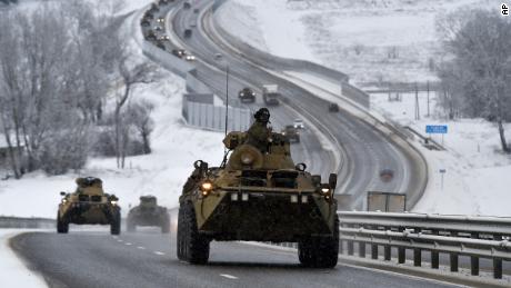 A convoy of Russian armored vehicles moves along a highway in Crimea, Tuesday, Jan. 18, 2022. Russia has concentrated an estimated 100,000 troops with tanks and other heavy weapons near Ukraine in what the West fears could be a prelude to an invasion. The Biden administration is unlikely to answer a further Russian invasion of Ukraine by sending U.S. combat troops. But it could pursue a range of less dramatic yet still risky options, including giving military support to a post-invasion Ukrainian resistance. (AP Photo)