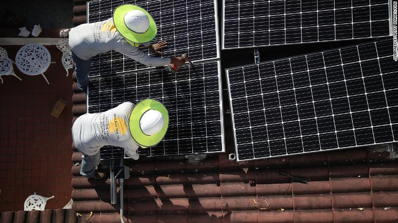 Solar panels are installed on a roof in Florida. A new poll shows the majority of Americans say the US should prioritize the development of renewable energy.