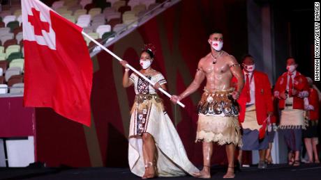 Flag bearers Malia Paseka and Pita Taufatofua of Team Tonga lead their team out during the Opening Ceremony of the Tokyo 2020 Olympic Games.
