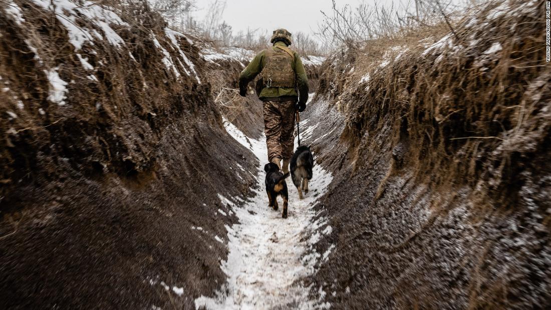 A soldier walks with dogs in a front-line trench. &quot;I&#39;ve been in the trenches many times before in the summer,&quot; Fadek said. &quot;This is the first time it was in the winter. Visually, because the trenches and the landscape are covered in snow, it reminds me of World War I trenches. Cold misery.&quot;