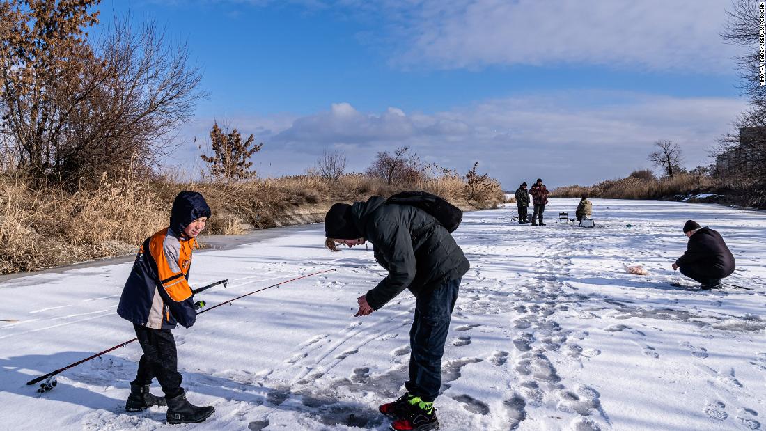 Boys fish for carp and perch in Marinka. &quot;They don&#39;t read the news and have no opinion about the Russian military buildup,&quot; Fadek said. &quot;But they said their parents were extremely worried and watch television news constantly.&quot;