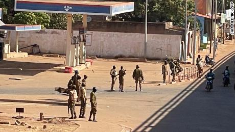 Soldiers outside a military base in Burkina Faso&#39;s capital Ouagadougou Sunday. Witnesses reported heavy gunfire nearby, raising fears that a coup attempt was underway.