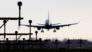 Rear view of various aircraft landing behind the runway lights in Amsterdam Schiphol International Airport in The Netherlands on November 18, 202