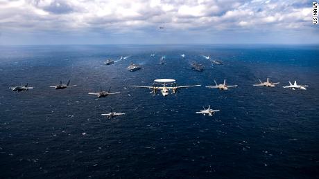 Aircraft fly over a US-Japan naval flotilla that included two US aircraft carriers in the Philippine Sea on Saturday.