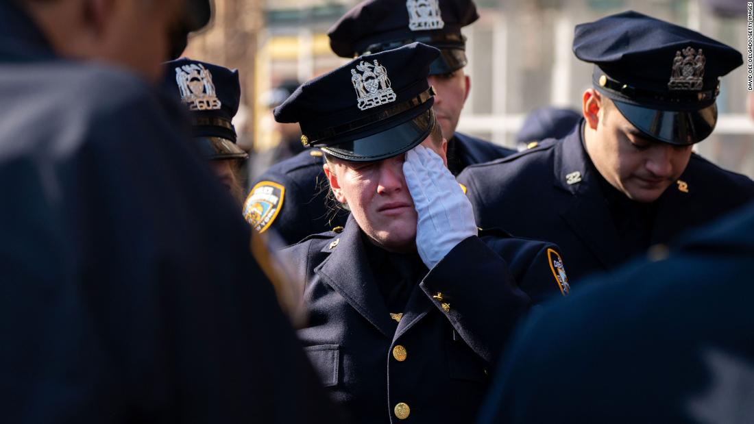 Fallen NYPD officer is honored by peers and another officer is in critical condition following shooting