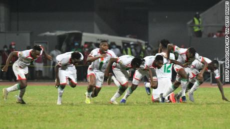 Burkina Faso&#39;s players celebrate beating Gabon on penalties.