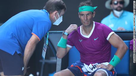 Rafael Nadal receives attention during treatment in his quarter-final match against Denis Shapovalov.