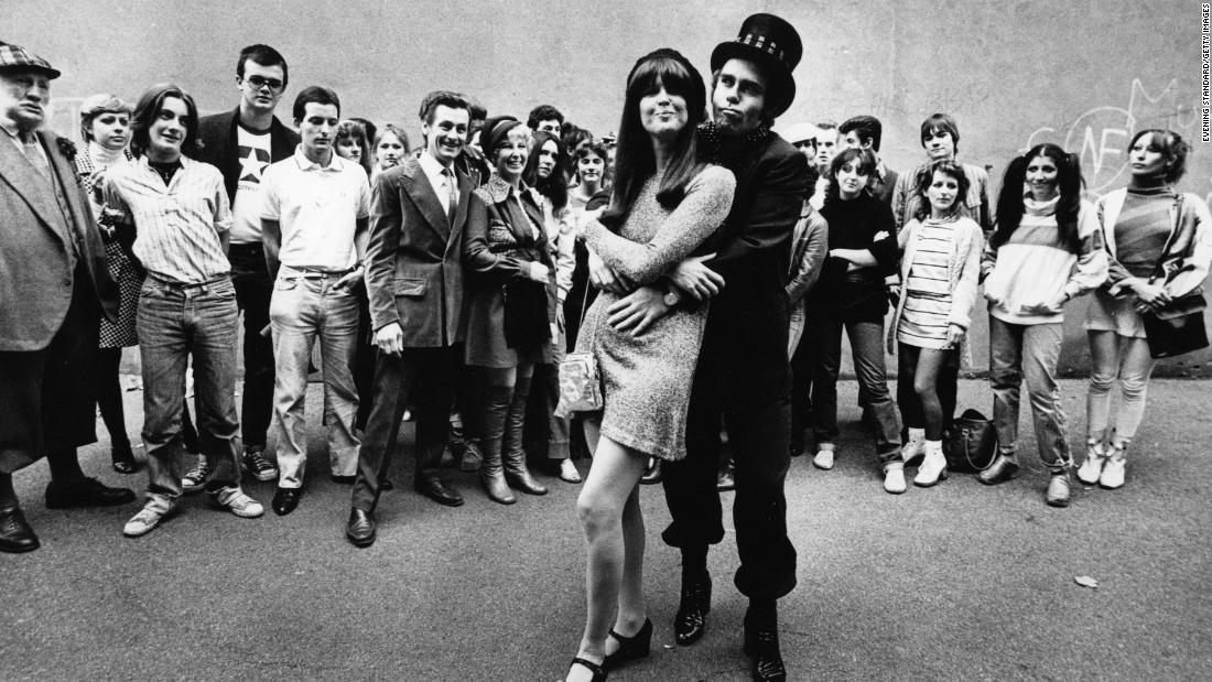 Fans watch John embrace singer and friend Kiki Dee in 1978. The two had a No. 1 hit, &quot;Don&#39;t Go Breaking My Heart,&quot; in 1976.