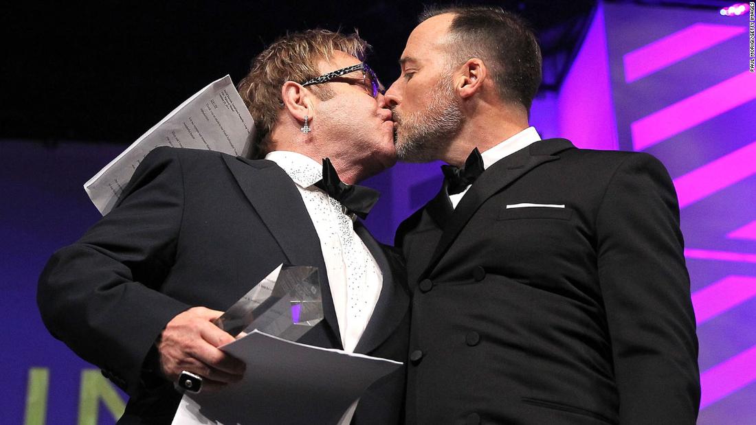 John and Furnish kiss at the Human Rights Campaign&#39;s National Dinner in 2014. They married in December of that year.