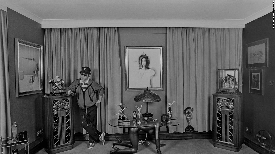 John stands in the bedroom of his home in Old Windsor, England, in 1978.