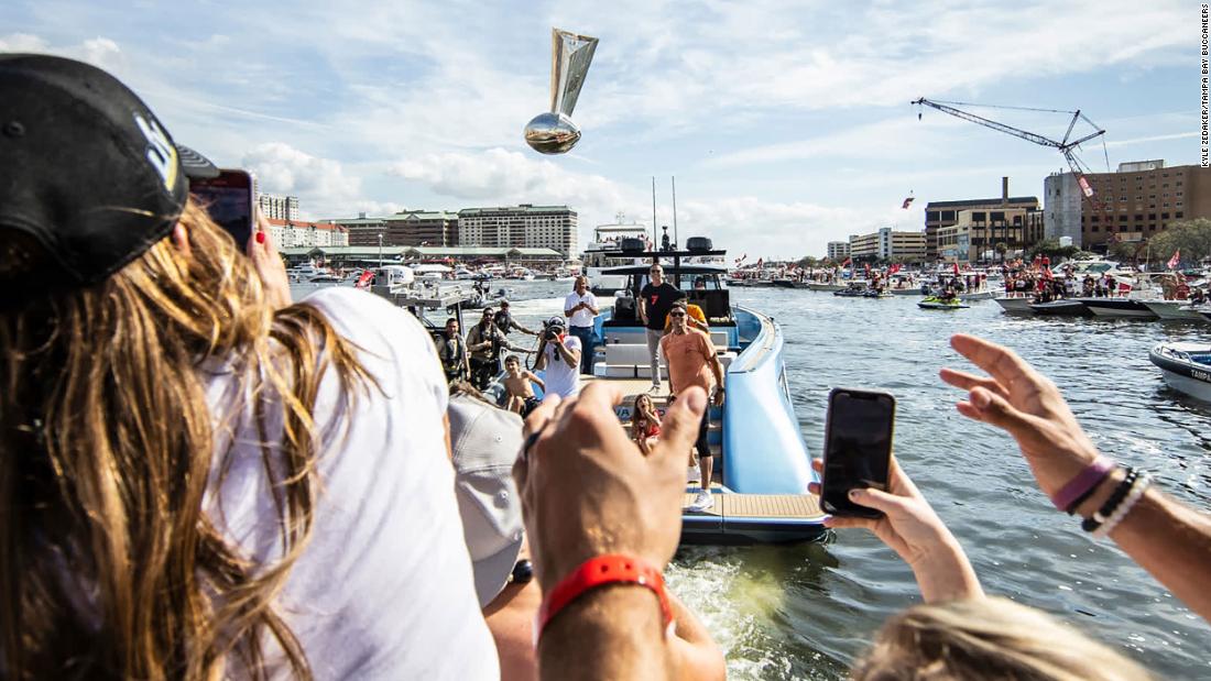 Brady throws the Vince Lombardi Trophy to teammates as they celebrate their title during a boat parade in Tampa, Florida, in February 2021.