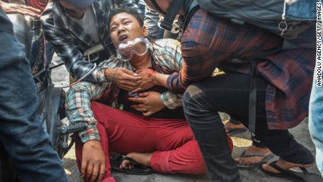 A wounded protester is seen after security forces intervene in protests against the military coup in Mandalay on March 27, 2021.