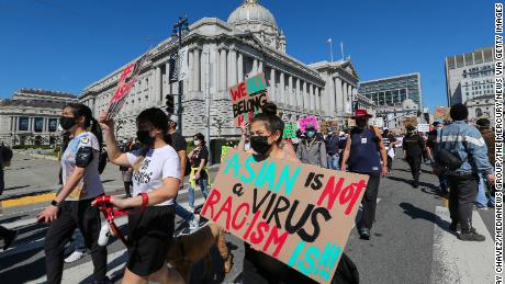 Demonstrators hold up signs as they take part in an anti-Asian American hate march and rally at San Francisco City Hall in San Francisco last year. 