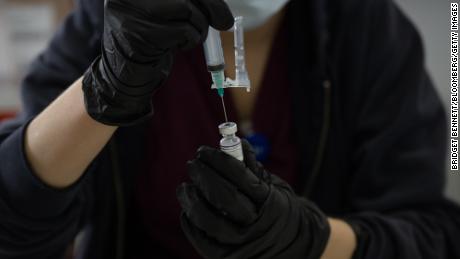 A healthcare worker prepares a Covid-19 vaccine at a Southern Nevada Health District testing site in Las Vegas, Nevada, on January 6, 2022. 
