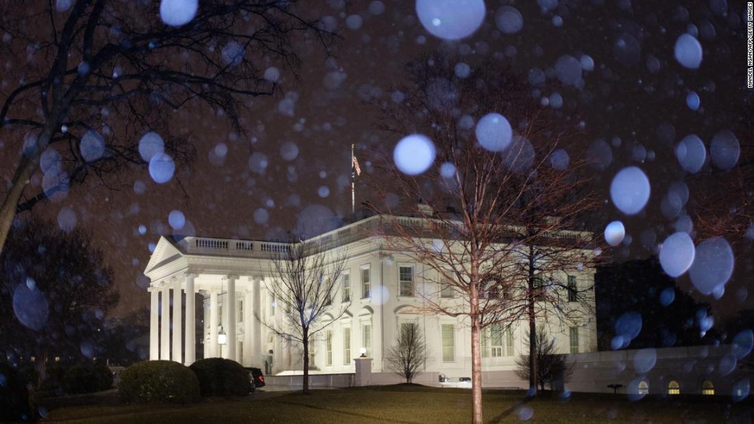 Snow falls around the White House in Washington, DC, on Friday.