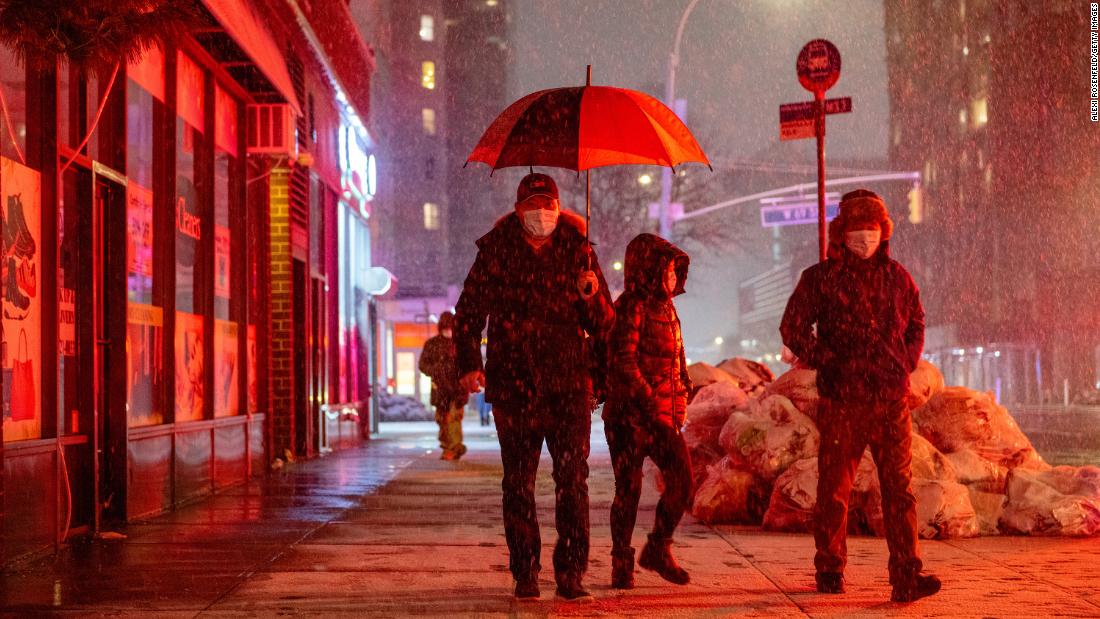 People walk through the snow on Friday, January 28, in New York City. 