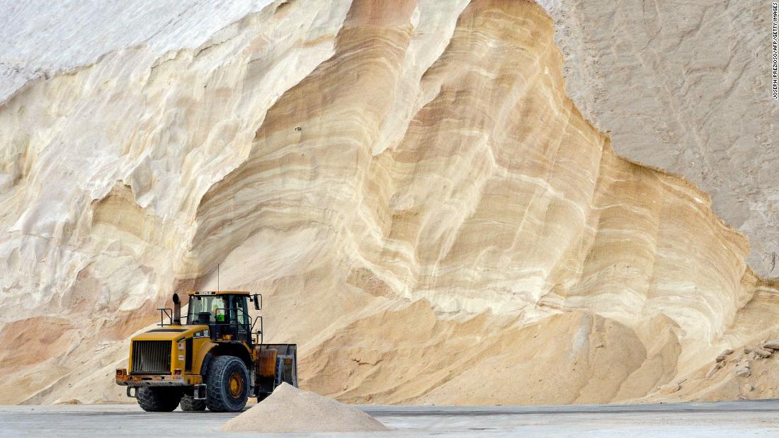 A bulldozer sits in front of a mountain of salt that will be used to treat roads and highways in Chelsea, Massachusetts, on Friday. 