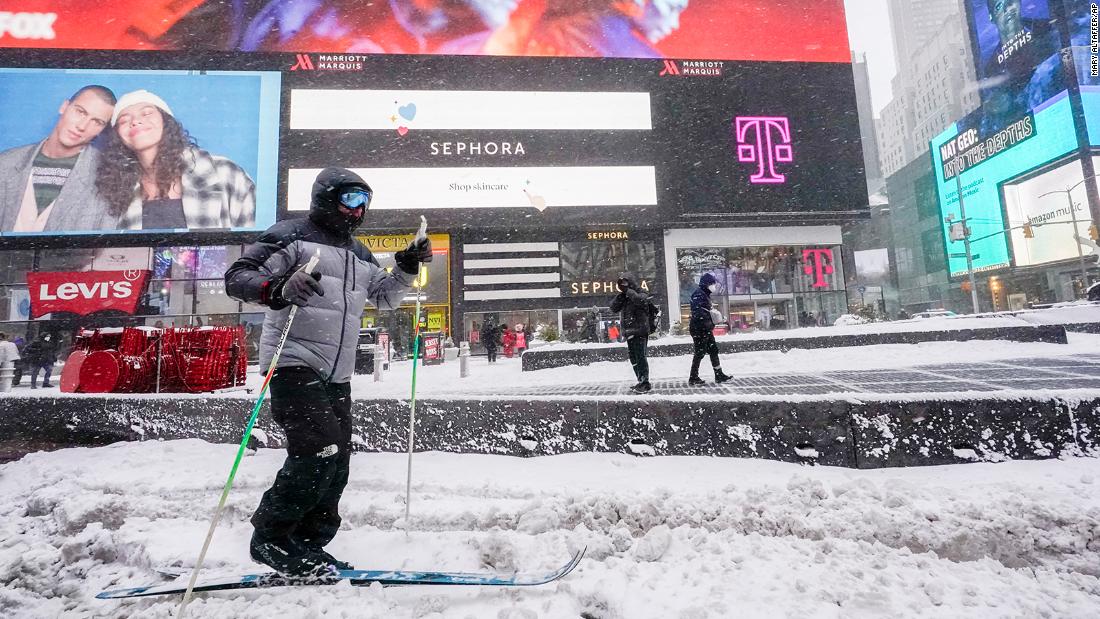 A person cross country skis through New York&#39;s Times Square during a snow storm on Saturday.