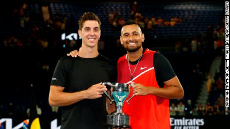 Thanasi Kokkinakis and Nick Kyrgios pose with the championship trophy after winning their men&#39;s doubles final.