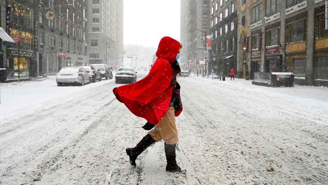 A woman crosses 57th Street during a winter storm that brought more than seven inches of snow and strong wind gusts to New York City, on January 29.