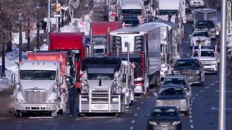Parked vehicles taking part in the protest block lanes on an Ottawa road Sunday. 
