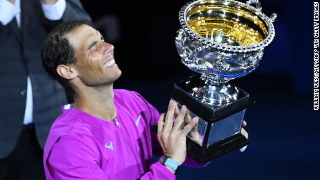 Rafael Nadal lifts a historic 21st grand slam trophy.