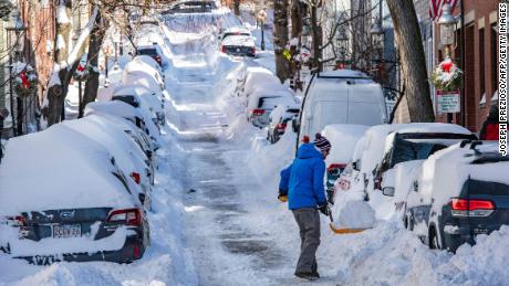 A person shovels snow in Boston, Massachusetts, on Sunday