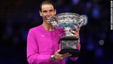 Rafael Nadal poses with the trophy after winning the 2022 Australian Open.