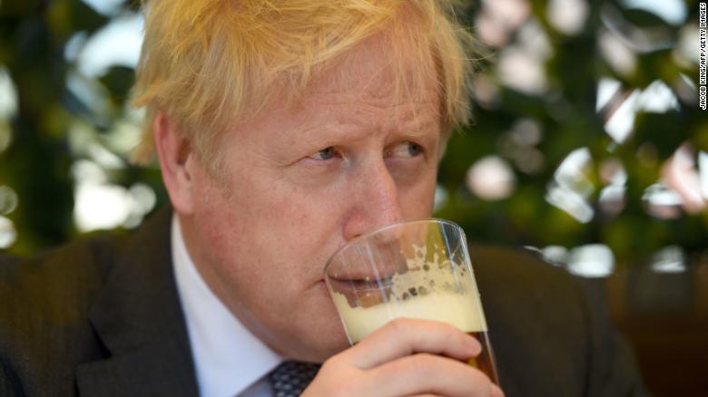 Boris Johnson sips a pint of beer at pub in Wolverhampton, central England, on April 19, 2021.