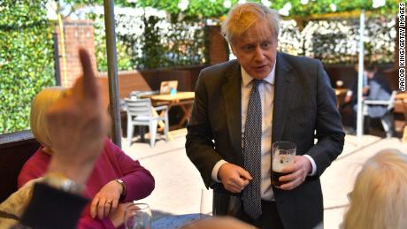 Prime Minister Johnson with customers at the beer garden during a visit to a pub on April 19, 2021.