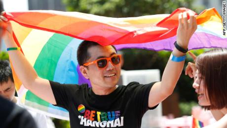 A man holds a rainbow flag after taking part in the Pride Run in Shanghai in June 2017. Shanghai Pride shut down abruptly in 2020 and has not returned since