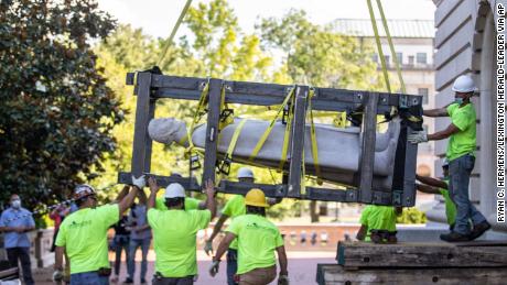 Workers hoist a statue of Jefferson Davis after removing it from the the Kentucky state Capitol in Frankfort on June 13, 2020.
