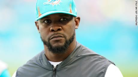 Miami Dolphins head coach Brian Flores stands on the field before an NFL football game against the New York Giants, Sunday, Dec. 5, 2021, in Miami Gardens, Fla. (AP Photo/Wilfredo Lee)