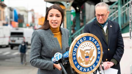 Democratic Rep. Alexandria Ocasio-Cortez speaks as then-Senate Minority Leader Chuck Schumer listens during a press conference in the Corona neighbourhood of Queens in April 2020 in New York City. 