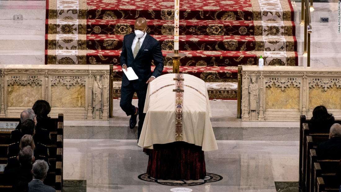 New York City Mayor Eric Adams touches Mora&#39;s casket after giving a eulogy at St. Patrick&#39;s Cathedral.