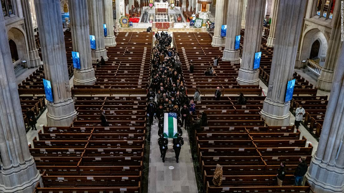 Mora&#39;s casket is carried out of St. Patrick&#39;s Cathedral following his funeral service. 